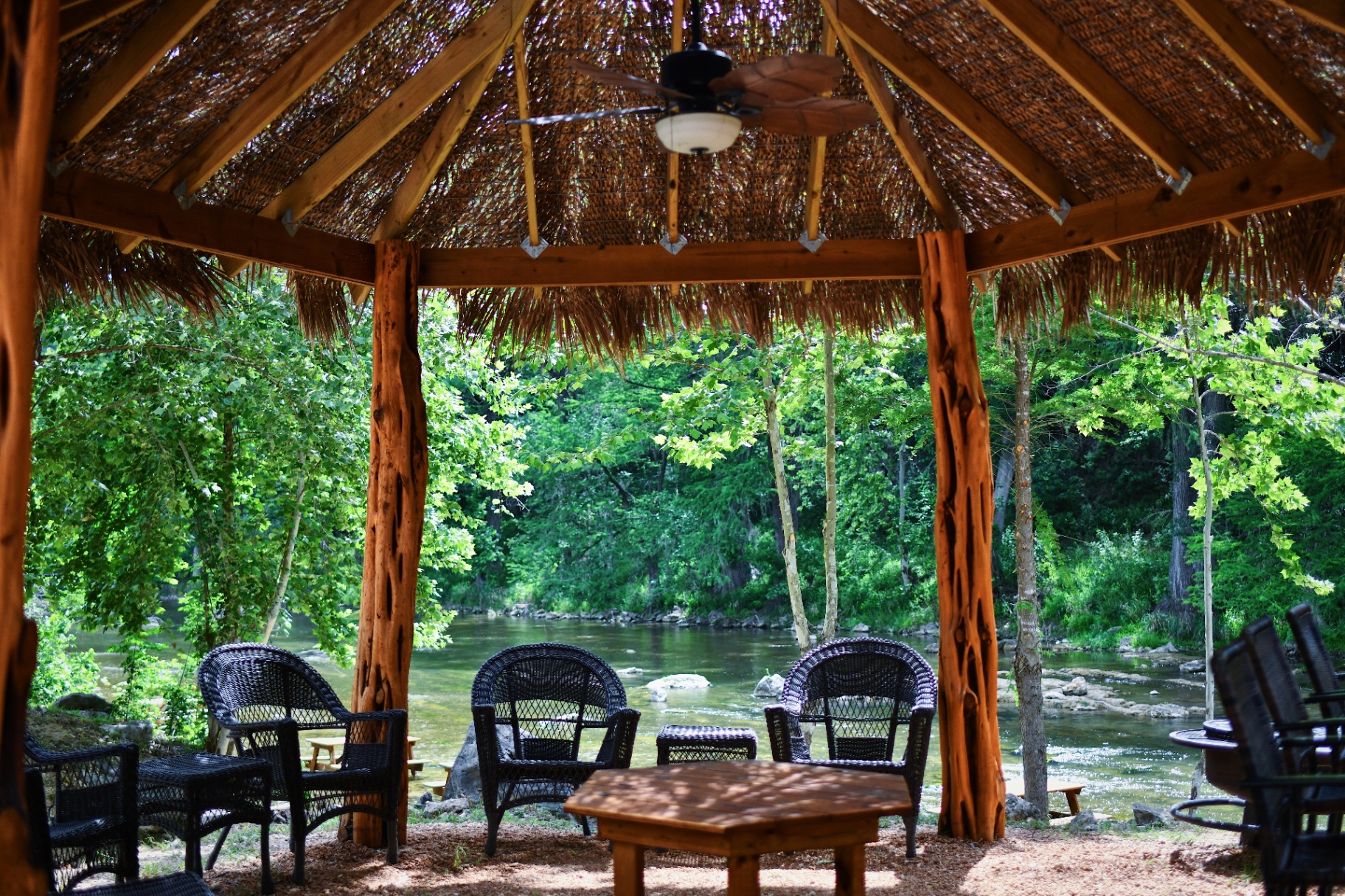 Inside view of a thatched cabana overlooking the river