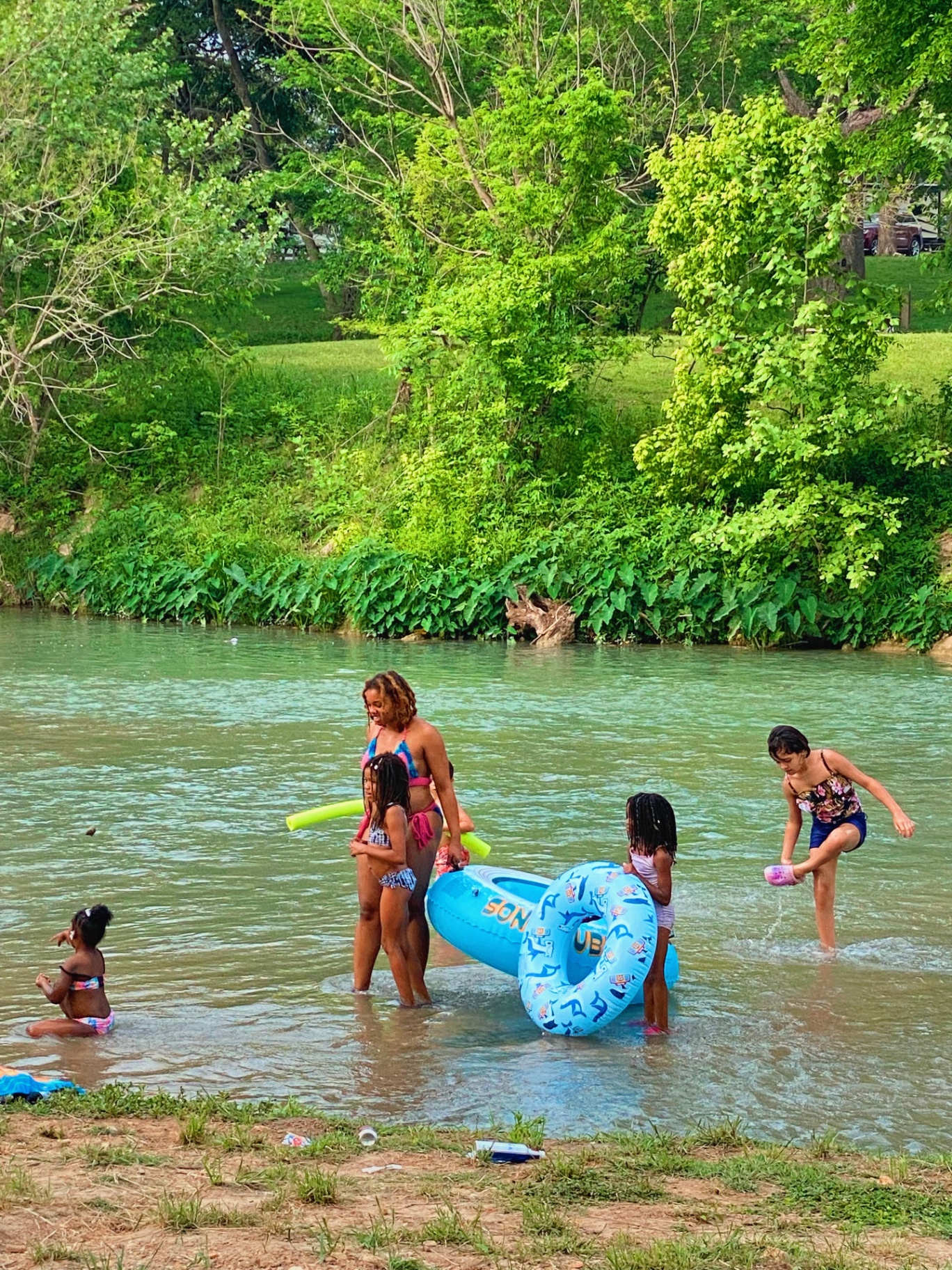 Family playing in the San Marcos River