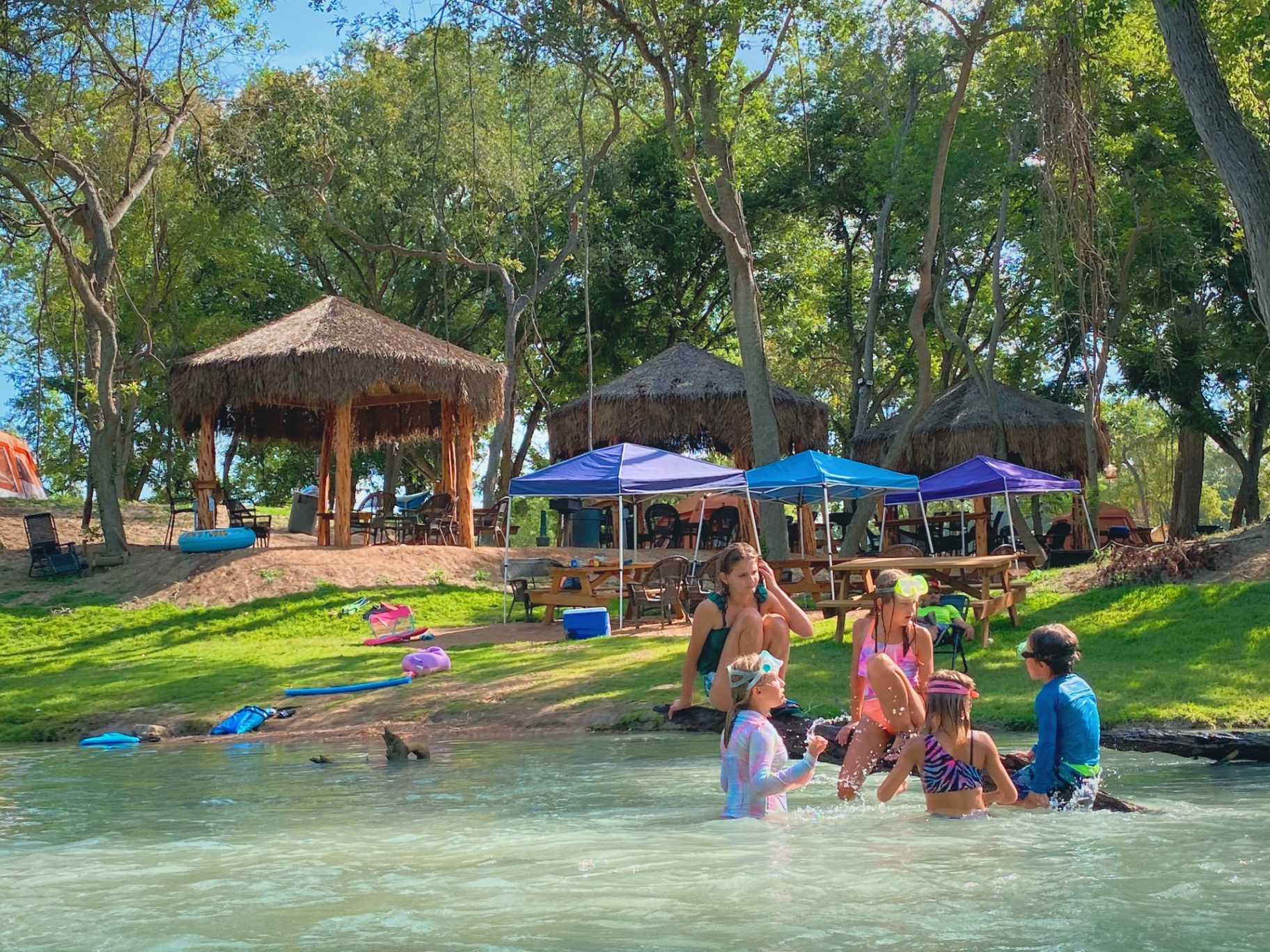 Kids playing near tiki huts
