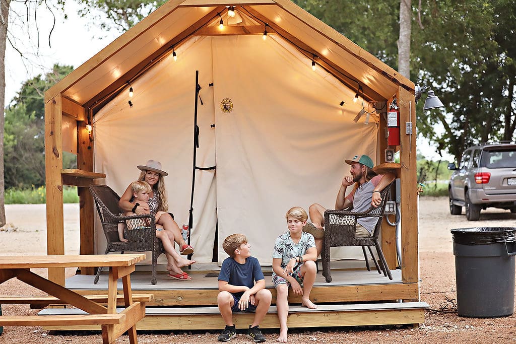 Luxury glamping bell tents lit at twilight in the Texas Hill Country near San Antonio